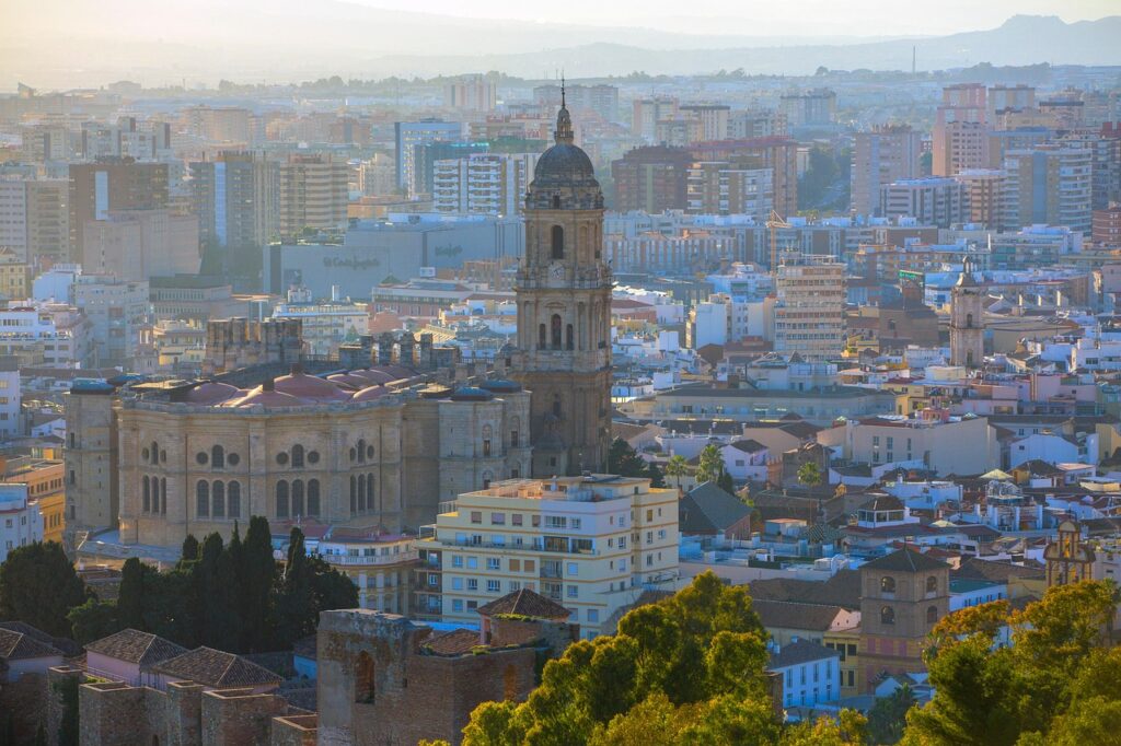 malaga cathedral - La Manquita facade with single tower against blue sky